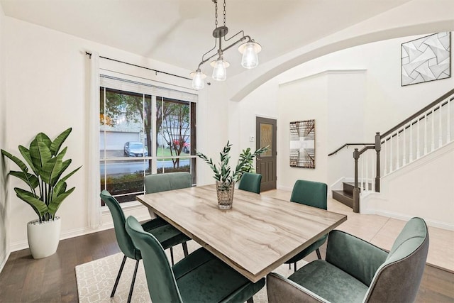 199 Limestone Trl, Austin, TX 78737 - dining space with arched walkways, stairs, and dark wood-style floors