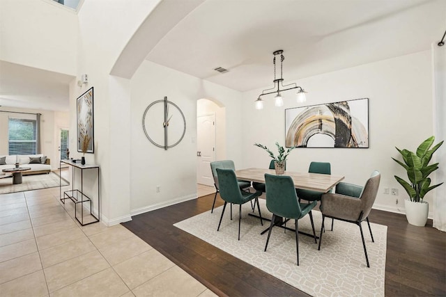 199 Limestone Trl, Austin, TX 78737 - dining space with arched walkways, wood finished floors, and a chandelier