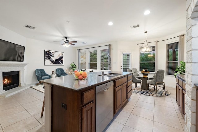 199 Limestone Trl, Austin, TX 78737 - kitchen with dishwasher, a warm lit fireplace, light tile patterned floors, ceiling fan, and recessed lighting