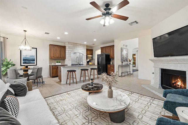 199 Limestone Trl, Austin, TX 78737 - living area with a ceiling fan, light tile patterned floors, a high end fireplace, recessed lighting, and arched walkways