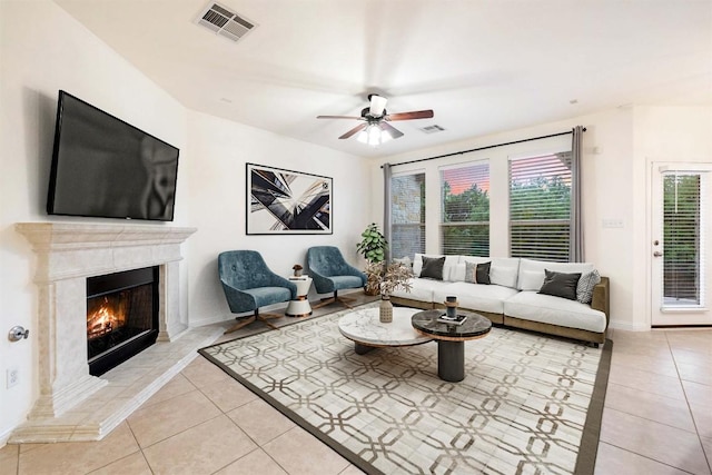 199 Limestone Trl Unit 73, Austin, TX 78737 - living room featuring light tile patterned floors, ceiling fan, a high end fireplace, and baseboards