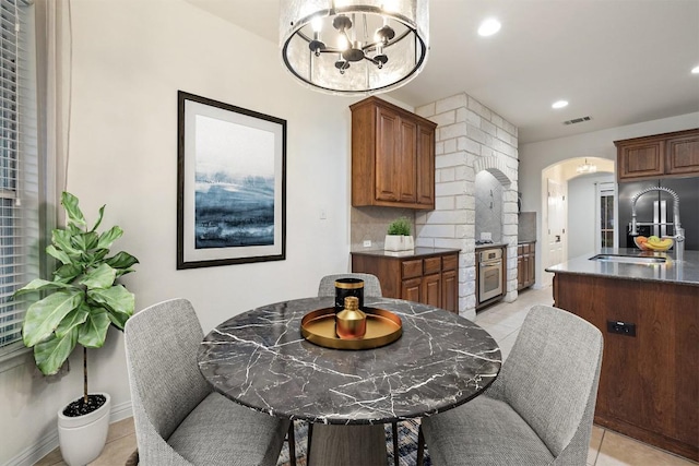 199 Limestone Trl, Austin, TX 78737 - dining space with arched walkways, light tile patterned flooring, a chandelier, and recessed lighting