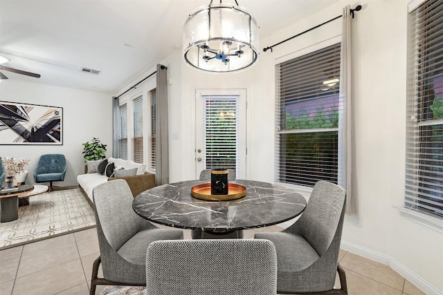199 Limestone Trl, Austin, TX 78737 - dining space featuring light tile patterned floors, a ceiling fan, and a chandelier