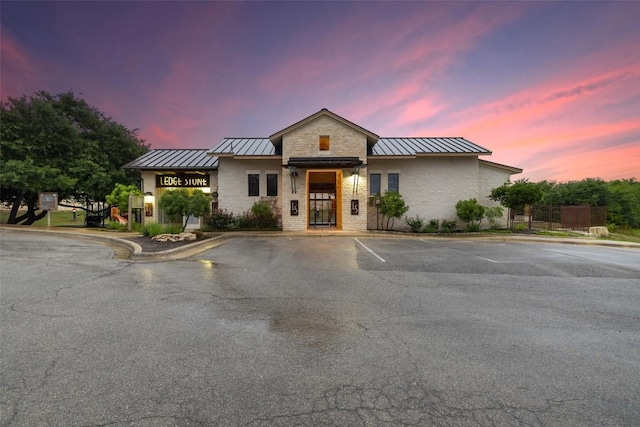 199 Limestone Trl, Austin, TX 78737 - view of front facade with a standing seam roof, a metal roof, and uncovered parking