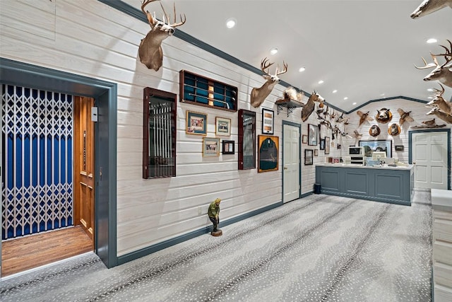 12 Hedge Ln, Austin, TX 78746 - kitchen with vaulted ceiling, recessed lighting, light countertops, wooden walls, and gray cabinetry