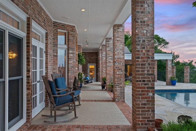 12 Hedge Ln, Austin, TX 78746 - patio terrace at dusk featuring french doors