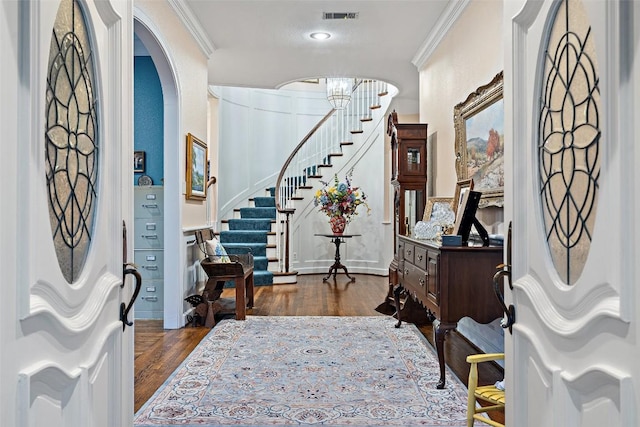 12 Hedge Ln, Austin, TX 78746 - foyer with crown molding, dark wood finished floors, stairs, a chandelier, and arched walkways