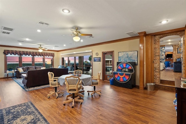 12 Hedge Ln, Austin, TX 78746 - dining space featuring ceiling fan, ornamental molding, wood finished floors, healthy amount of natural light, and baseboards