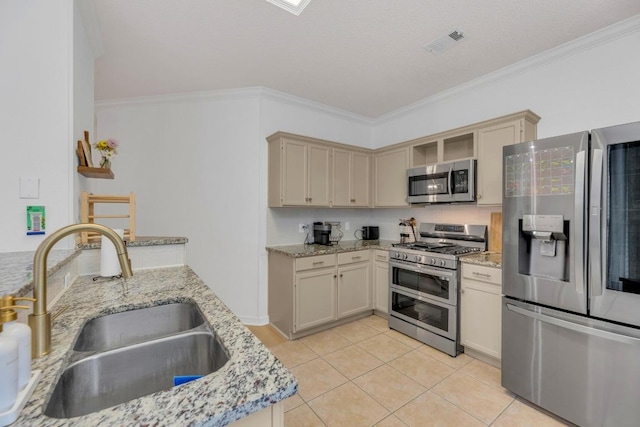 kitchen with appliances with stainless steel finishes, a sink, ornamental molding, light tile patterned floors, and light stone counters