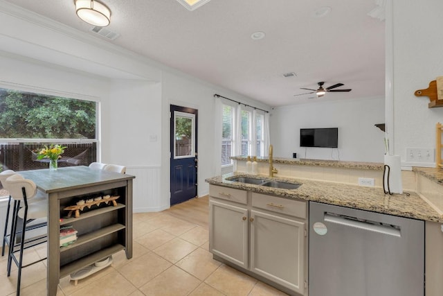 kitchen with dishwasher, a sink, light stone counters, a ceiling fan, and a peninsula