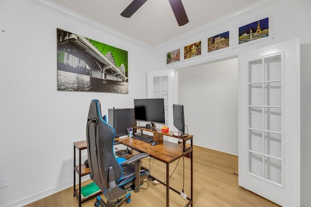office area with crown molding, a ceiling fan, wood finished floors, and baseboards
