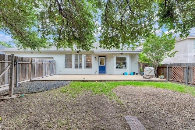 back of house featuring a patio and a fenced backyard