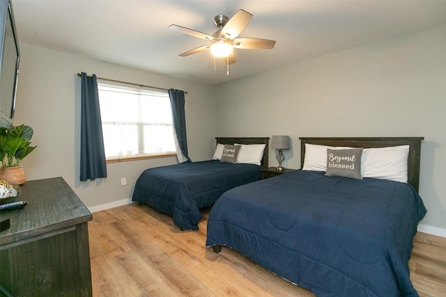 104 Cove E Unit 103, Horseshoe Bay, TX 78657 - bedroom with light wood-type flooring, baseboards, and ceiling fan