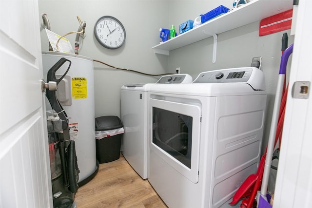 104 Cove E Unit 103, Horseshoe Bay, TX 78657 - washroom featuring water heater, washer and clothes dryer, and light wood-style floors