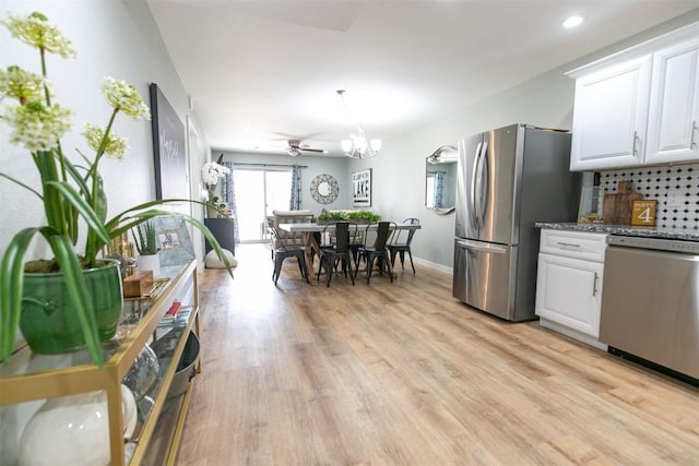 104 Cove E Unit 103, Horseshoe Bay, TX 78657 - kitchen featuring freestanding refrigerator, white cabinets, light wood-style floors, stove, and recessed lighting