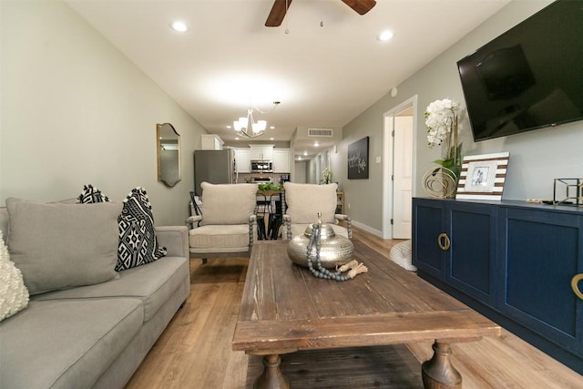 104 Cove E Unit 103, Horseshoe Bay, TX 78657 - living area with a chandelier, a ceiling fan, light wood-style floors, and recessed lighting