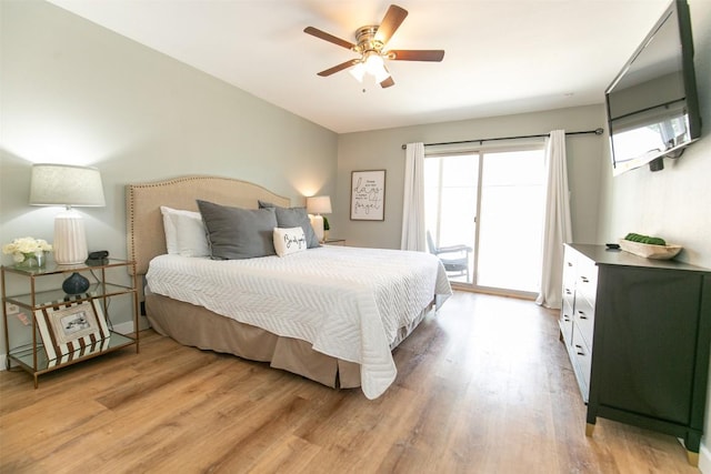 104 Cove E Unit 103, Horseshoe Bay, TX 78657 - bedroom with access to outside, light wood finished floors, and a ceiling fan