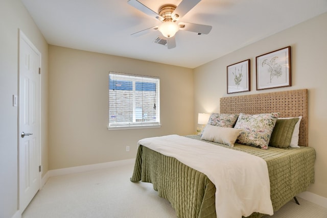bedroom with light colored carpet, baseboards, and a ceiling fan