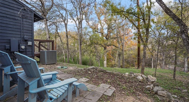 13918 Hummingbird Ln, Austin, TX 78732 - view of yard featuring central AC unit and a patio area