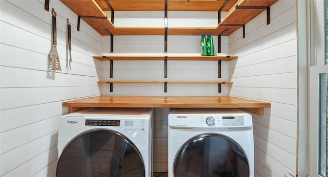 13918 Hummingbird Ln, Austin, TX 78732 - clothes washing area with washer and dryer and wood walls