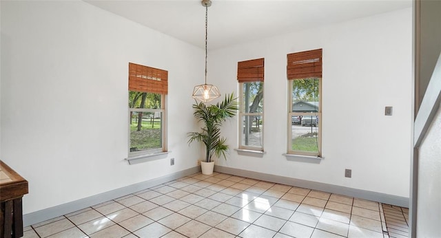 13918 Hummingbird Ln, Austin, TX 78732 - unfurnished dining area with plenty of natural light, light tile patterned flooring, and baseboards
