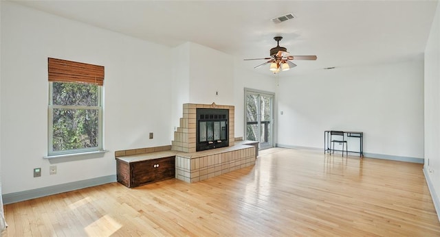 13918 Hummingbird Ln, Austin, TX 78732 - unfurnished living room with plenty of natural light, light wood-style flooring, ceiling fan, and baseboards