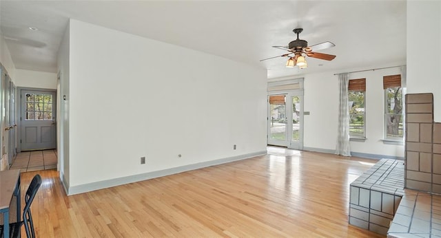 13918 Hummingbird Ln, Austin, TX 78732 - unfurnished living room featuring light wood-type flooring, ceiling fan, and baseboards