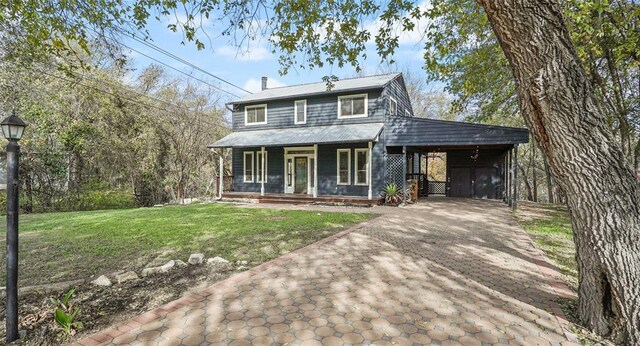 13918 Hummingbird Ln, Austin, TX 78732 - view of front of property with covered porch, decorative driveway, a front lawn, and an attached carport