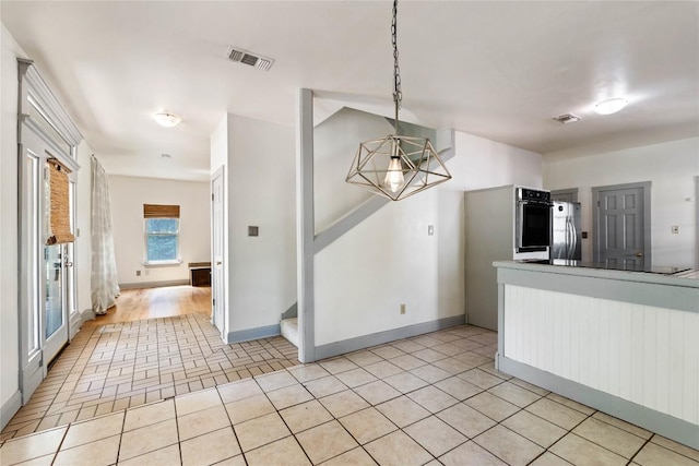13918 Hummingbird Ln, Austin, TX 78732 - kitchen with a chandelier, stainless steel appliances, baseboards, and hanging light fixtures