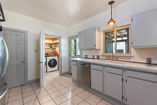 13918 Hummingbird Ln, Austin, TX 78732 - kitchen featuring washer / clothes dryer, a sink, stainless steel dishwasher, light countertops, and gray cabinetry