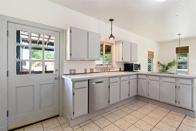13918 Hummingbird Ln, Austin, TX 78732 - kitchen featuring stainless steel appliances, light tile patterned floors, light countertops, hanging light fixtures, and a sink