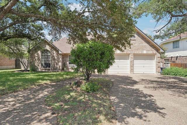 7403 Ponoma Trl, Austin, TX 78749 - view of property hidden behind natural elements with a front lawn, brick siding, and driveway