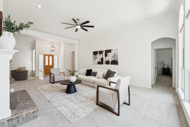 7403 Ponoma Trl, Austin, TX 78749 - living area featuring arched walkways, ornamental molding, light carpet, ceiling fan, and healthy amount of natural light