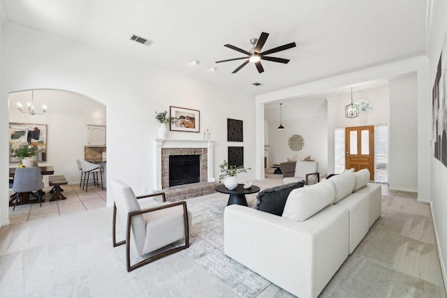 7403 Ponoma Trl, Austin, TX 78749 - living area with a chandelier, a brick fireplace, ceiling fan, ornamental molding, and arched walkways
