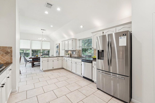 7403 Ponoma Trl, Austin, TX 78749 - kitchen featuring appliances with stainless steel finishes, tasteful backsplash, a sink, a chandelier, and recessed lighting