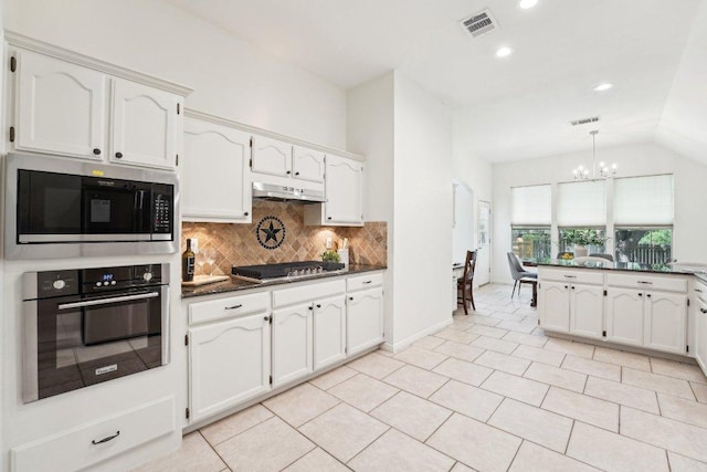 7403 Ponoma Trl, Austin, TX 78749 - kitchen with appliances with stainless steel finishes, a chandelier, dark countertops, backsplash, and under cabinet range hood