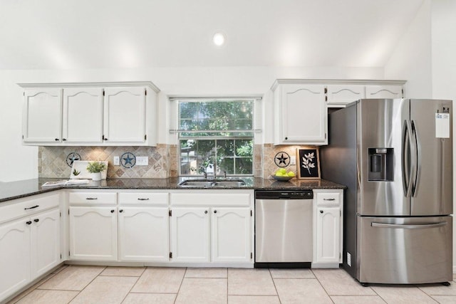 7403 Ponoma Trl, Austin, TX 78749 - kitchen featuring appliances with stainless steel finishes, a sink, dark stone countertops, white cabinetry, and backsplash