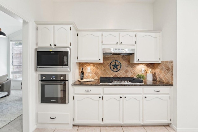 7403 Ponoma Trl, Austin, TX 78749 - kitchen with appliances with stainless steel finishes, under cabinet range hood, dark stone counters, and white cabinets