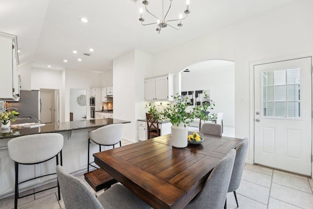 7403 Ponoma Trl, Austin, TX 78749 - dining room featuring arched walkways, light tile patterned floors, a chandelier, and recessed lighting
