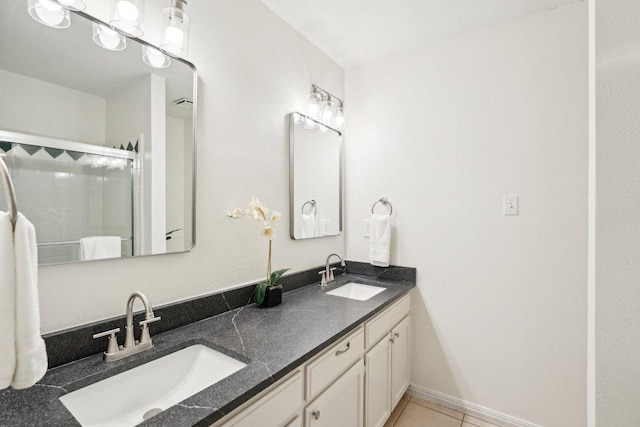 7403 Ponoma Trl, Austin, TX 78749 - full bath featuring double vanity, a stall shower, and tile patterned flooring