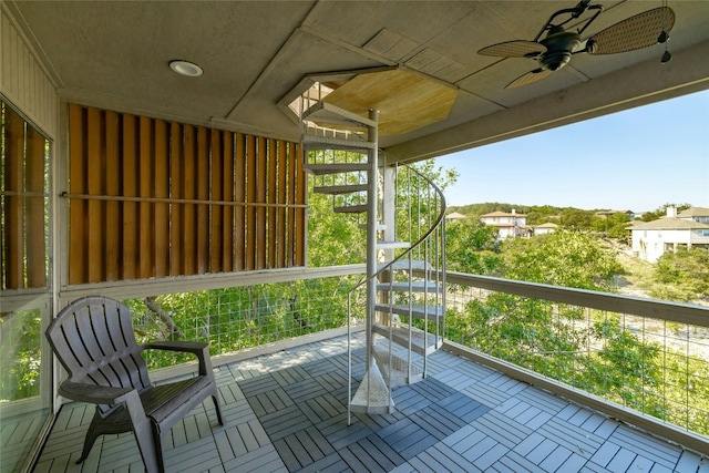 view of patio with a ceiling fan and a balcony