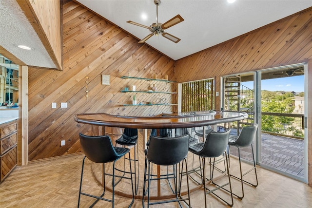 bar featuring wood walls, ceiling fan, recessed lighting, and lofted ceiling