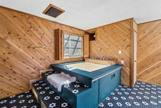 recreation room featuring wood walls, carpet, and a textured ceiling