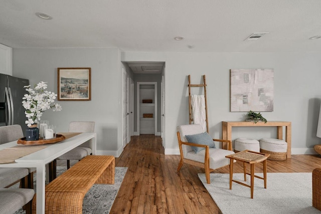 dining room with baseboards, wood finished floors, and recessed lighting