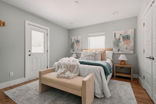 bedroom featuring baseboards and wood finished floors