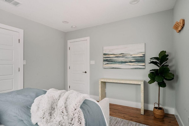bedroom featuring wood finished floors, baseboards, and recessed lighting