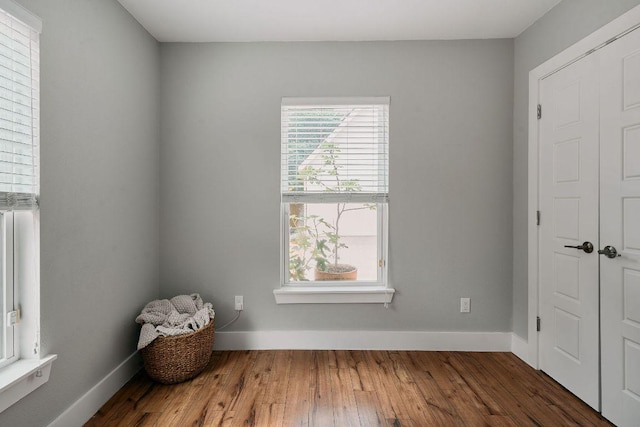 unfurnished bedroom with wood finished floors and baseboards