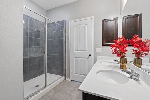 1180 Verna Brooks Way, Kyle, TX 78640 - bathroom with tile patterned flooring, a stall shower, and double vanity