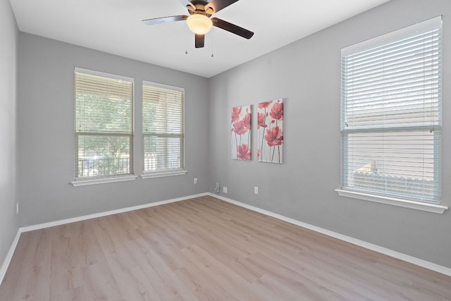 1180 Verna Brooks Way, Kyle, TX 78640 - spare room with wood finished floors, a ceiling fan, and baseboards