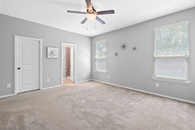 1180 Verna Brooks Way, Kyle, TX 78640 - unfurnished bedroom with carpet flooring, baseboards, ensuite bathroom, and a ceiling fan